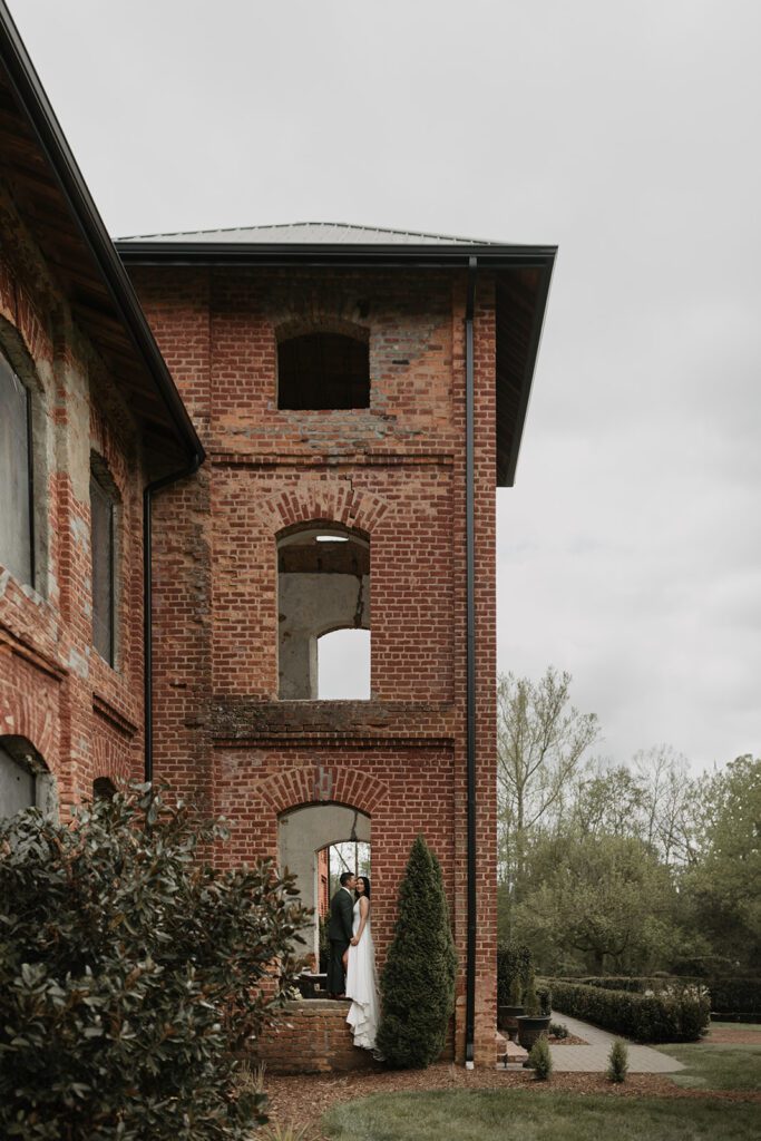 bride-and-groom-posing-for-editorial-style-portrait-in-tower