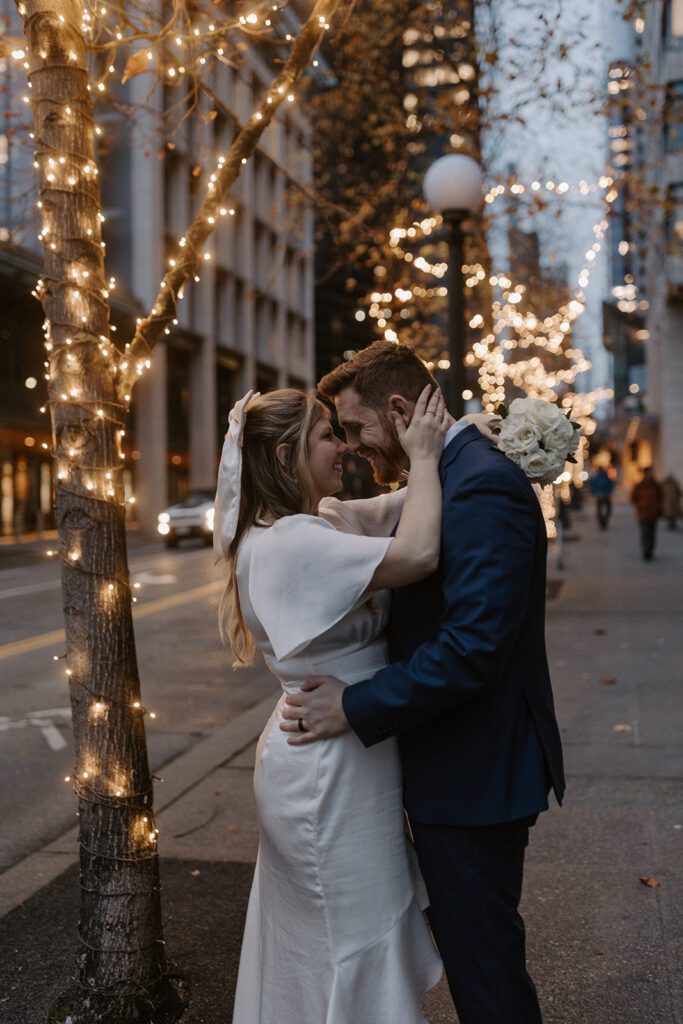 bride and groom cheering down the steps of the king county courthouse after their elopement