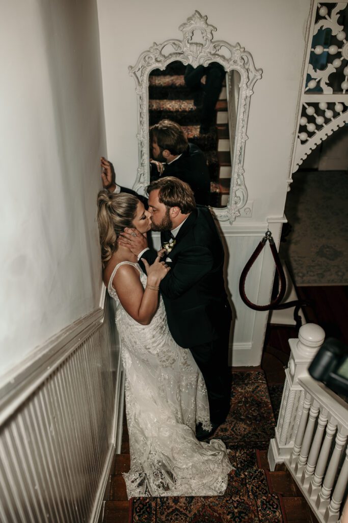direct flash portrait of bride and groom kissing in a mansion.