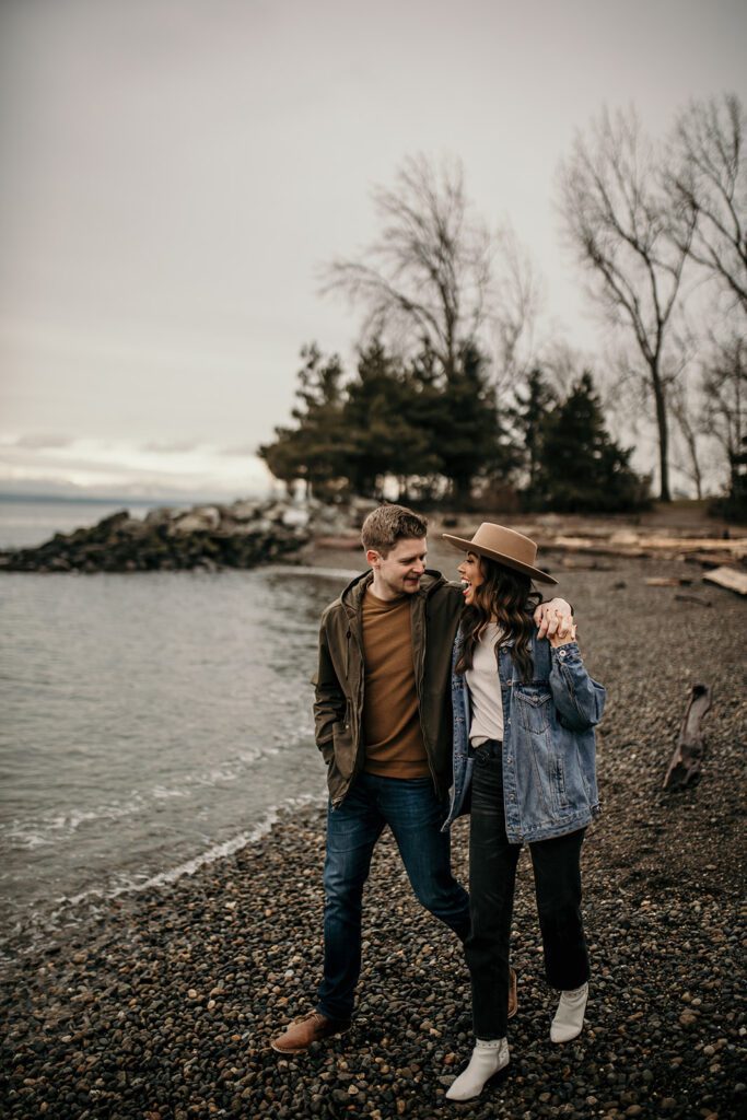 engaged couple sharing a walk on secret beach near downtown Seattle for their engagements