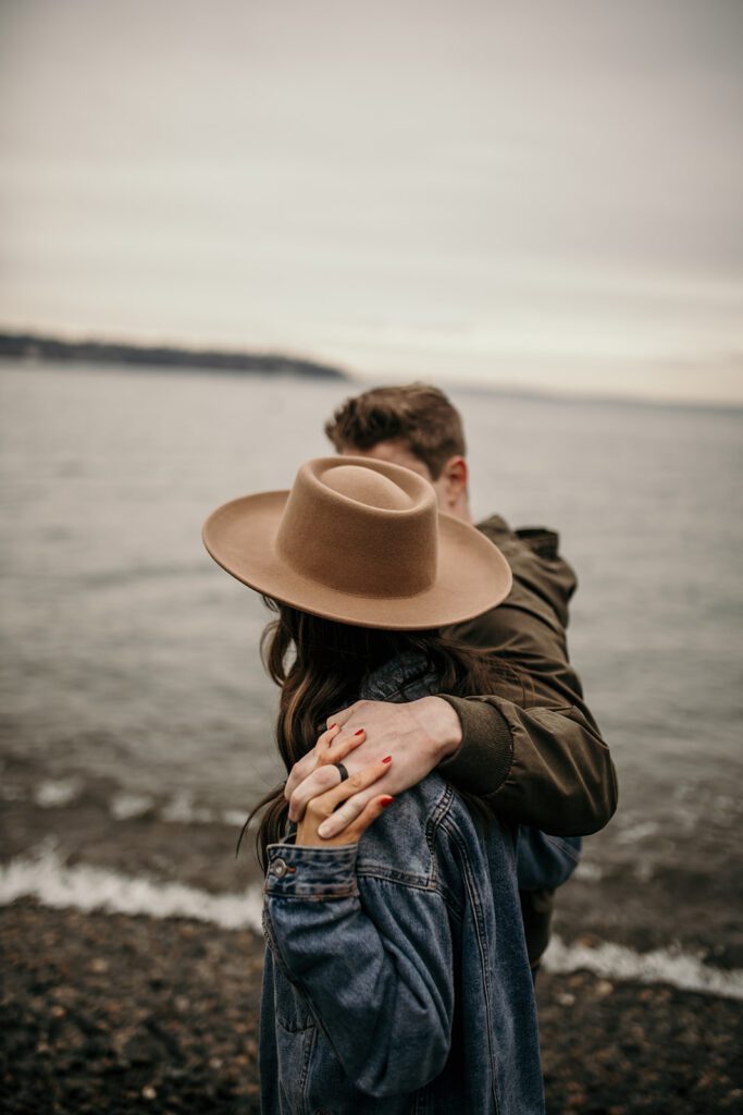 couple wearing a fedora for their engagement session 