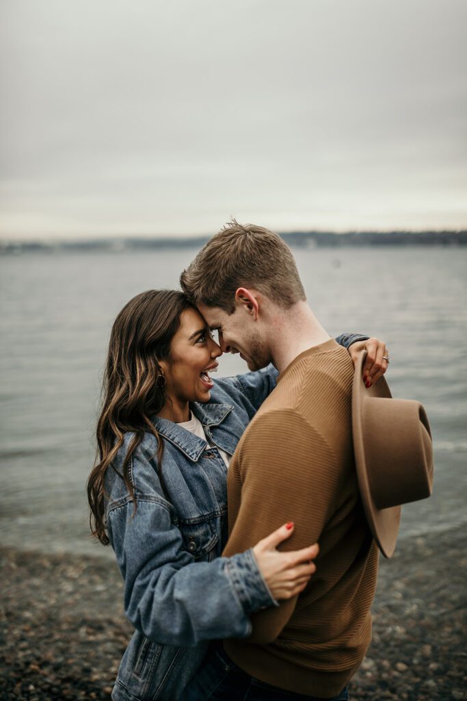 outdoor engagement session at secret beach near downtown Seattle with the Olympic mountains visible in the background.