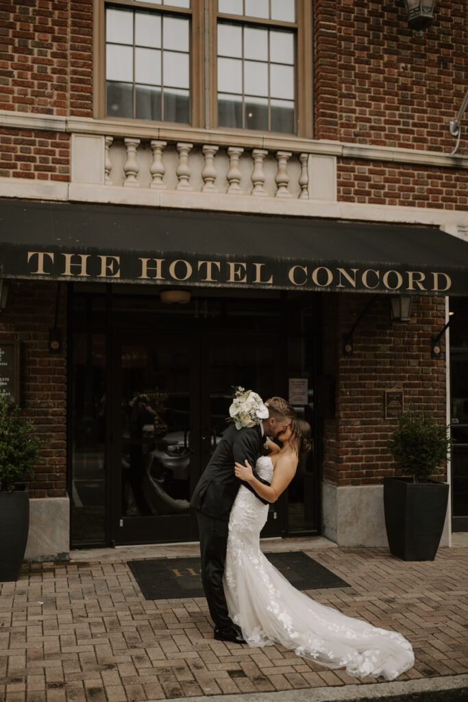 bride-and-groom-sharing-a-kiss-in-front-of-the-hotel-concord