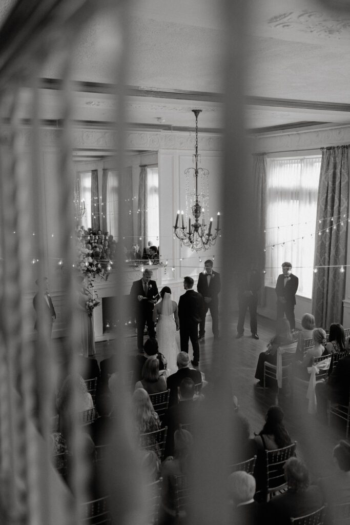 view-of-bride-and-groom-sharing-vows-from-the-balcony-of-the-wedding-venue