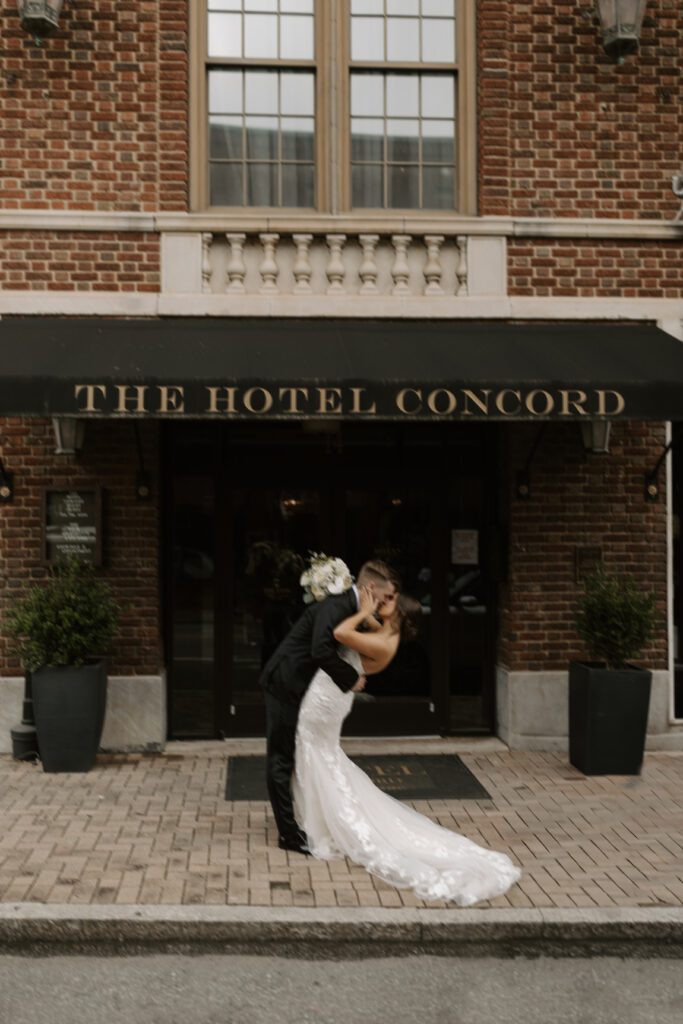 bride-and-groom-kissing-in-front-of-the-hotel-concord