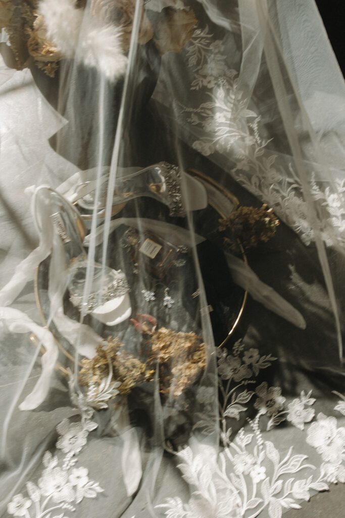 modern-wedding-flatlay-with-jewel-tones-dried-florals-badgley-mischka-heels-and-direct-light