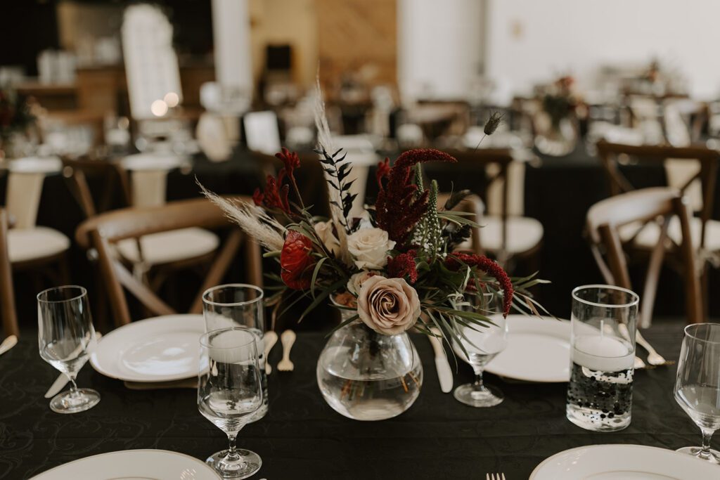 moody-wedding-reception-with-jewel-tone-florals-and-black-tablecloths