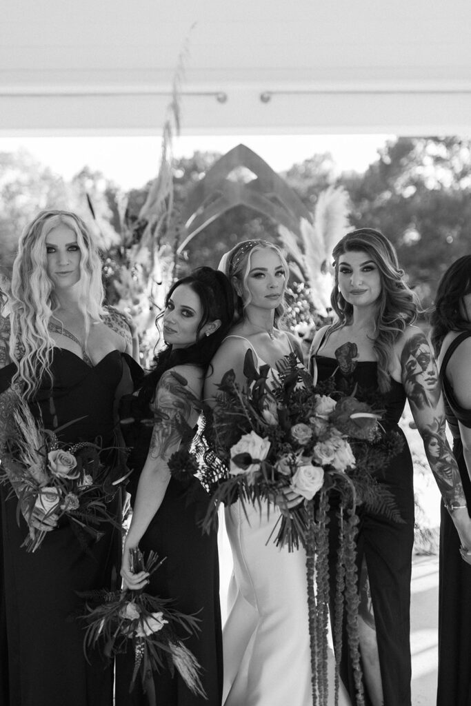 bridesmaids-in-mixmatched-black-satin-dresses-and-jewel-toned-bouquets