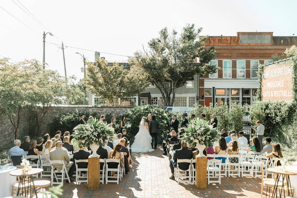 courtyard wedding ceremony with historic buildings in the background at Bakery 105