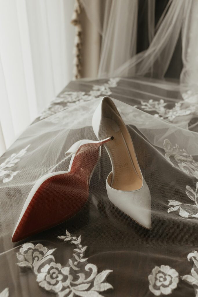 luxury bridal details featuring red bottom heels and a cathedral lace veil for a castle wedding