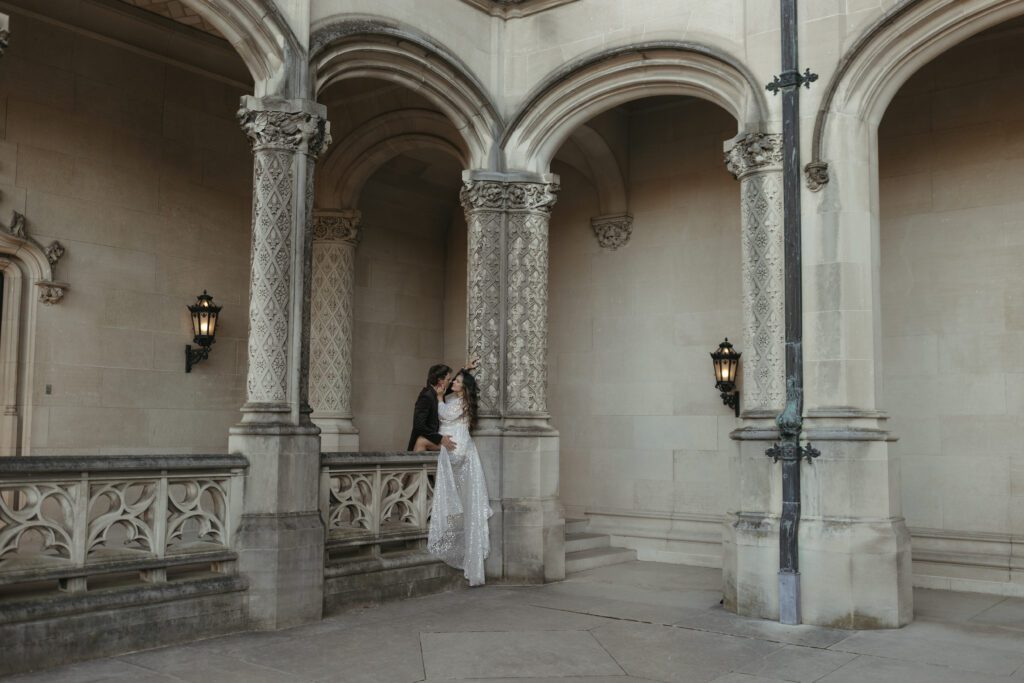 luxury Biltmore estate wedding photos by the arches of the mansion