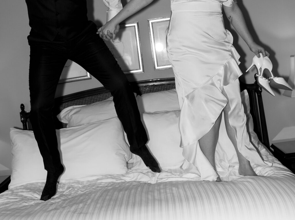bride and groom jumping on bed with direct flash photos