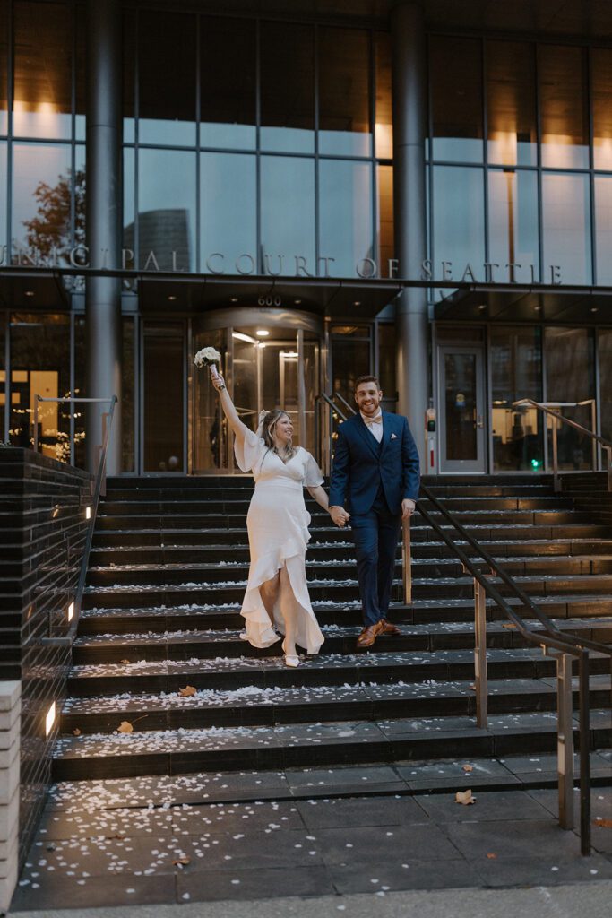 couple kissing on the steps of the king county courthouse after their elopement